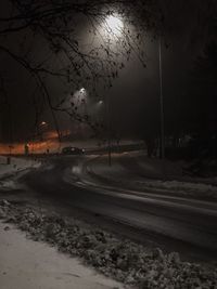 Street against sky during winter at night