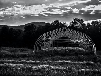 Built structure on field against sky