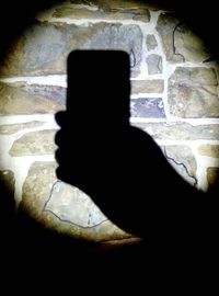 Shadow of person holding smart phone