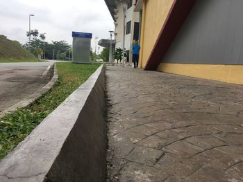 Surface level of footpath amidst buildings in city