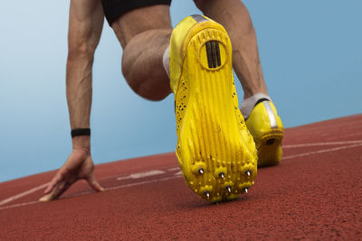 Low section of male athlete at starting line