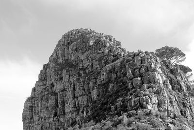 Low angle view of rock formation against sky