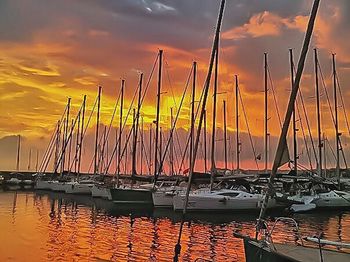 Boats in harbor at sunset