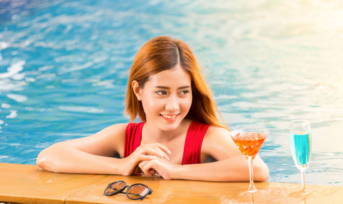 Portrait of smiling young woman in swimming pool