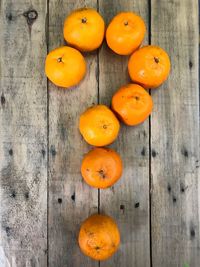 Close-up of orange fruits on wood