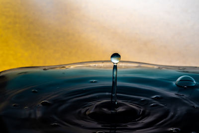 Close-up of drop falling on water surface