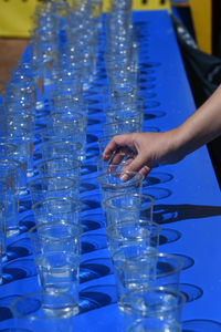 Many glasses of water, a hand is taking one glass