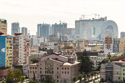 High angle view of buildings in city against sky