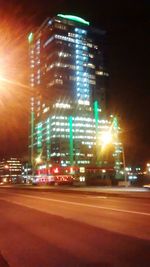 Illuminated city street at night