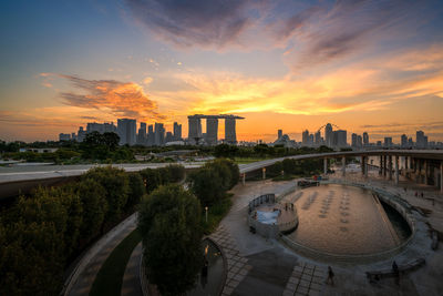 Buildings in city against sky during sunset