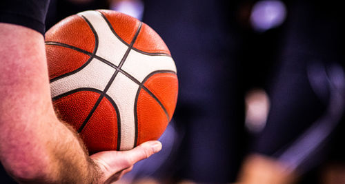 Cropped hand holding basketball