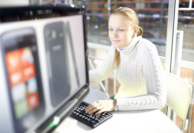 Happy woman using computer at office