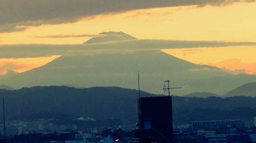 Scenic view of mountains against sky at sunset