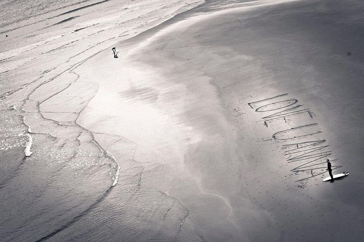 high angle view, sand, footprint, text, nature, travel, tranquility, transportation, day, beach, communication, outdoors, unrecognizable person, tranquil scene, scenics, aerial view, vacations, water, beauty in nature