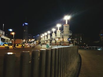 Illuminated city against sky at night