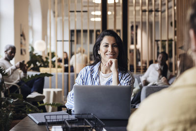 Young woman using laptop at table