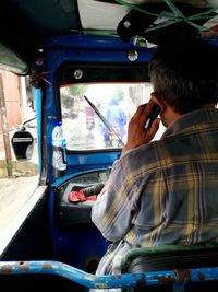 Rear view of man traveling vehicle