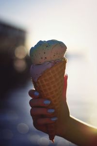 Close-up of hand holding ice cream cone