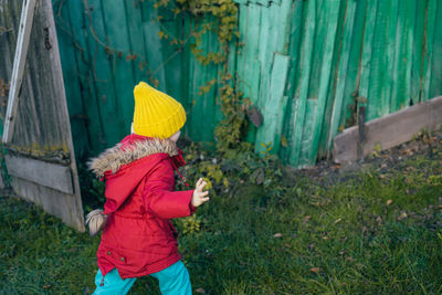 Rear view of woman standing against plants