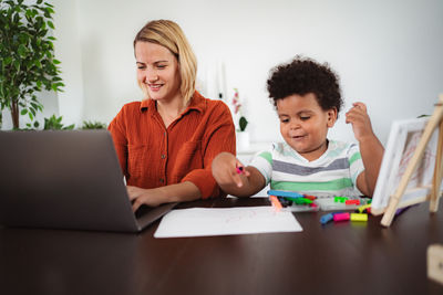 Portrait of happy family sitting on table