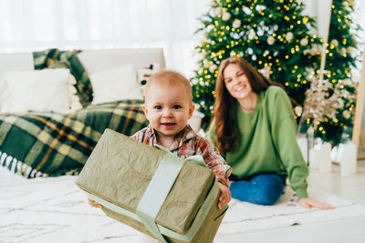 Portrait of smiling boy reading book