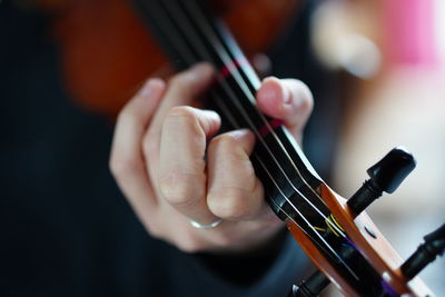 Midsection of musician playing violin