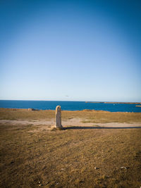 Scenic view of beach against blue sky