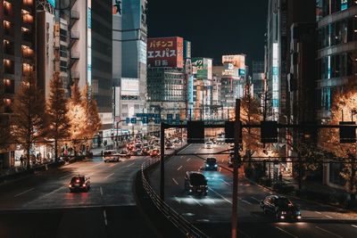 Traffic on city street and buildings at night