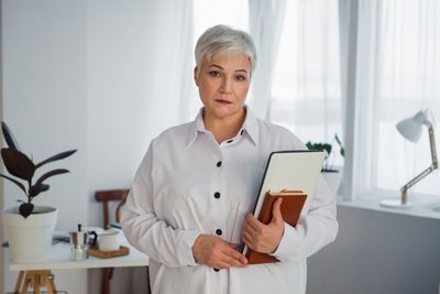 Portrait of woman standing at office