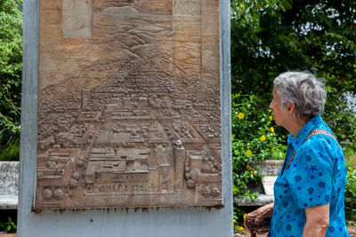 Senior woman tourist visiting the commemorative monument of the armero tragedy