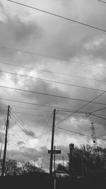 Low angle view of power lines against sky