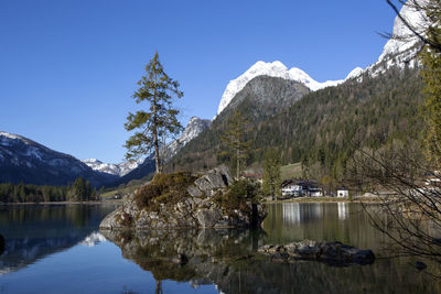 Scenic view of lake and snowcapped mountains against sky