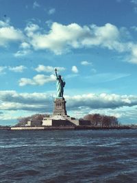 Statue of liberty against cloudy sky