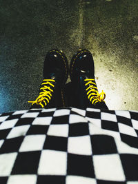 Low section of person standing on tiled floor