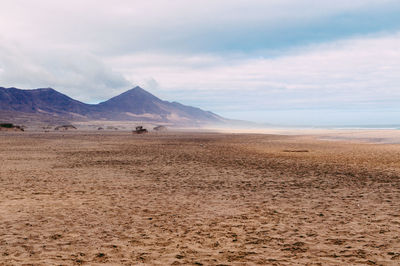 Scenic view of mountains against cloudy sky