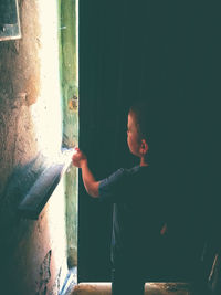 Boy standing against wall