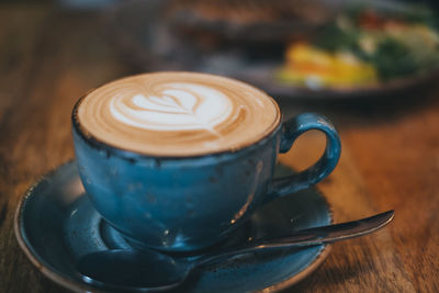 Close-up of cappuccino served on table