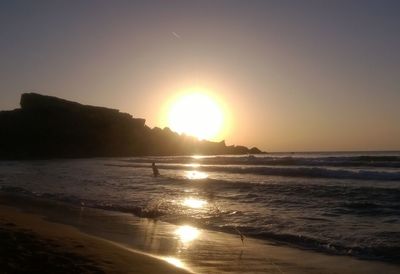 Scenic view of sea against clear sky during sunset