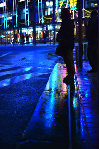 Reflection of people in water at night