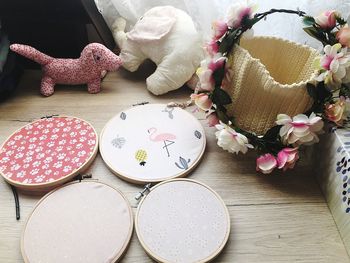 High angle view of embroidery frames by basket and stuffed toys on floor