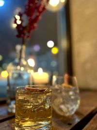 Close-up of illuminated tea light on table