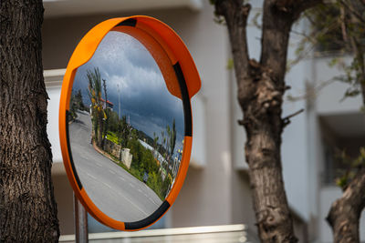 Road round mirror. mirror to help transport. help cornering. red round mirror on a post. 