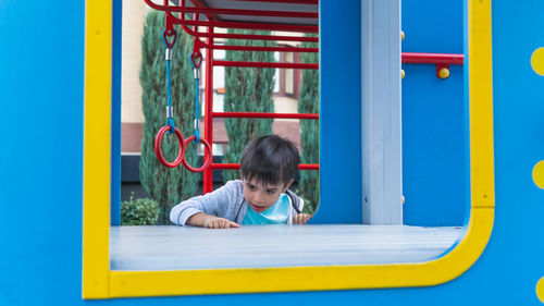 Close-up of cute boy playing in playground