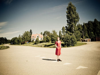 Rear view of woman standing on a road crossing