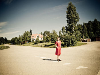 Rear view of woman walking on road