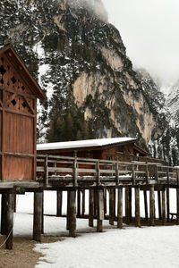 Built structure on snow covered land against sky