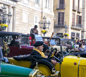 People sitting on street in city