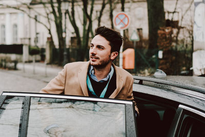 Man using mobile phone while sitting in car