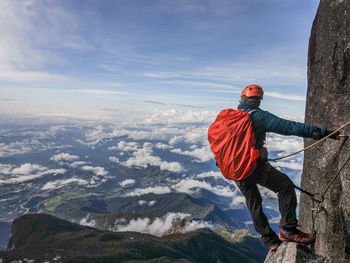 Man standing on mountain against sky