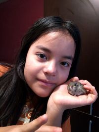 Portrait of smiling girl holding indoors